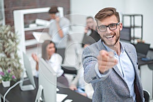 Close up. smiling businessman pointing finger at you