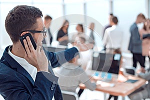 close up. smiling businessman talking on his smartphone