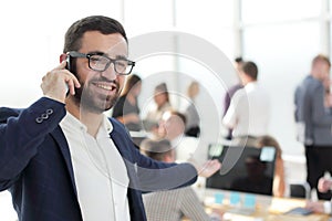 close up. smiling businessman talking on his smartphone
