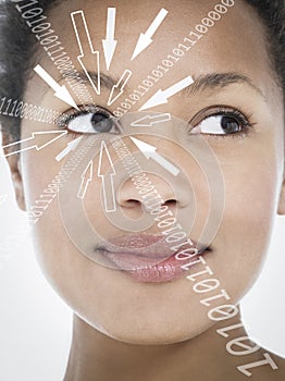 Close-up of smiling businesswoman with binary digits and arrow signs moving towards her eye against white background