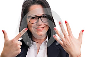 Close-up of smiling businesswoman showing number seven