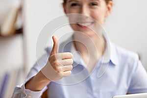 Close up smiling businesswoman showing thumbs up, satisfied client