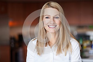 Close up Of A Smiling Caucasien blond woman in the kitchen at the office