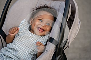 Close up of a smiling cute baby in a craddle