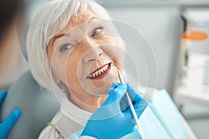 Close up of smiling elderly lady at the dentist office