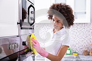 Janitor Cleaning Oven In The Kitchen photo