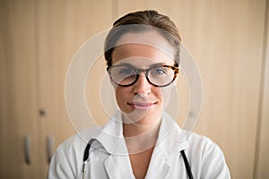 Close-up of smiling female practitioner wearing eyeglasses