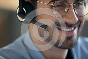 Close up smiling friendly man wearing headset with microphone