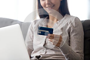Close up of smiling girl hold credit card shopping online