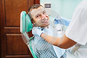 Close-up of a smiling, happy patient. Came for an examination to the clinic. No dental problems were found. Smooth, white teeth