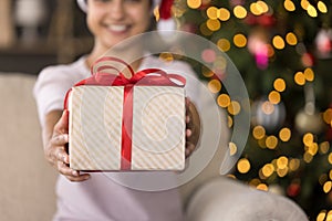 Close up smiling Indian woman holding gift box.