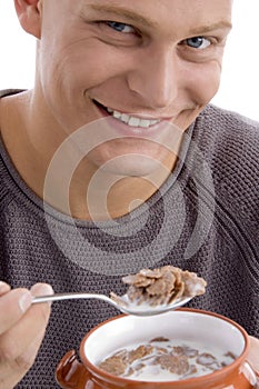 Close up of smiling man going to eating cornflakes