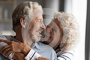 Close up smiling older couple hugging, enjoying tender moment