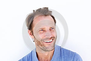 Close up smiling older man against white wall