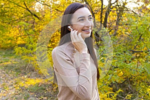 Close up of a smiling pretty young girl with wireless earphones