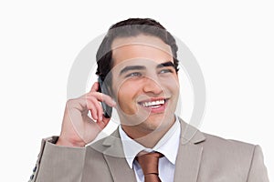 Close up of smiling salesman on his cellphone