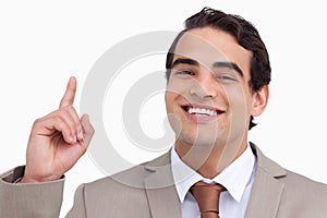 Close up of smiling salesman pointing up