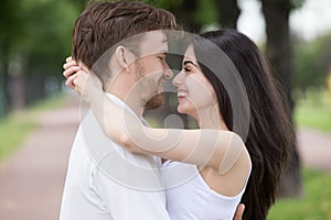 Close up of smiling sensual couple hugging looking in eyes