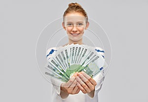 Close up of smiling teenage girl with euro money