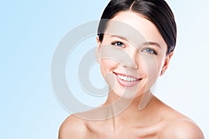 Close-up of smiling woman`s face. Perfect skin and Nude makeup.