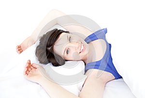 Close-up of a smiling woman waking up slowly