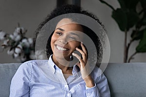 Smiling African American woman talk on smartphone call