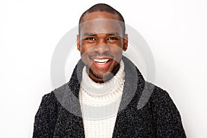 Close up smiling young black man with coat by isolated white background