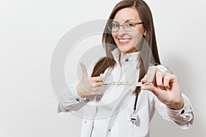 Close up smiling young doctor woman in medical gown with stethoscope, glasses showing thumbs up. Focus on clinical