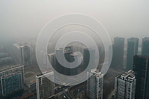 close-up of smoggy city skyline, with buildings and roads obscured