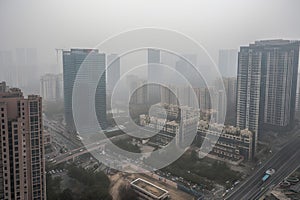 close-up of smoggy city skyline, with buildings and roads obscured