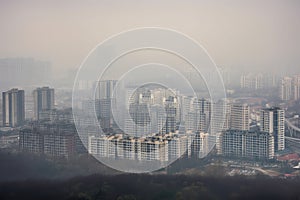 close-up of smoggy city skyline with buildings and structures visible