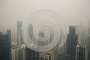 close-up of smoggy city skyline, with the tall buildings fading into the haze