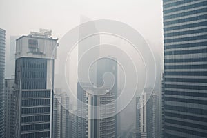 close-up of smoggy city skyline, with the tall buildings fading into the haze