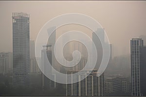 close-up of smoggy city skyline, with the tall buildings fading into the haze