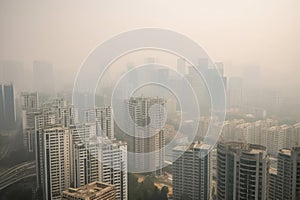 close-up of smoggy city skyline, with tall buildings obscured by toxic haze
