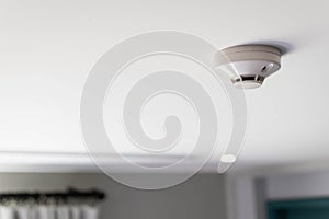 Close up of a smoke detector  attached on the ceiling of the hotel room