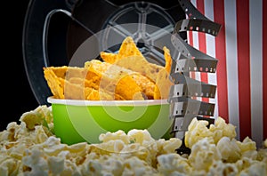 Close-up of snacks at the cinema bar, with videotape and a bucket of nachos