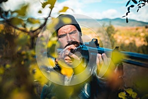Close up snipers carbine at the outdoor hunting. Man holding shotgun. Hunter with shotgun gun on hunt. Deer hunt.