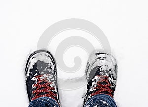 Close-up of  snow-covered boots  durring  winter photo