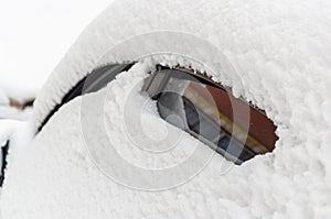 Close-up of snow-covered side of a car