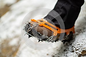 Close up of snow shoes and shoe spikes in winter.