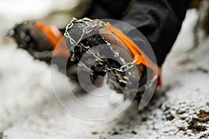 Close up of snow shoes and shoe spikes in winter.