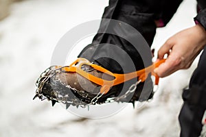 Close up of snow shoes and shoe spikes in winter.