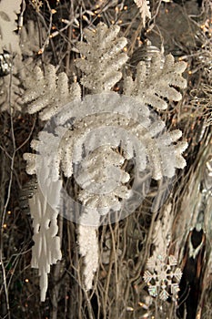 Close up of snowflake ornament hanging in window