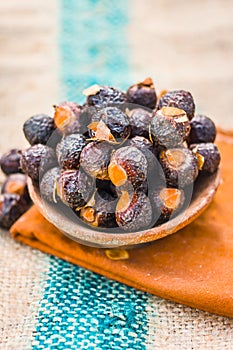 Close up of soap nut .Sapindus in a clay bowl on a gunny bag.