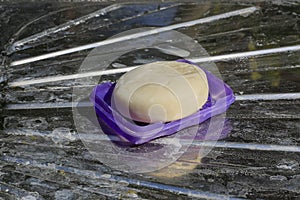 Close-up of the soap, placed on a stainless steel floor with a dirty class