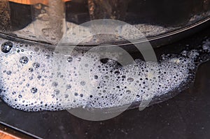 Close-up of soapy bubbles and foam on a dark surface, abstract texture