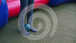 Close-up of a soccer ball at the feet of a man.