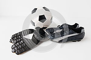 Close up of soccer ball, football boots and gloves