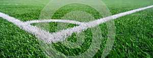 Close-up of a soccer field corner line. The lush green of pitch is shown in close detail. Ready for a football match